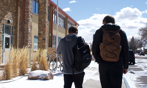 two students walking on campus in a winter