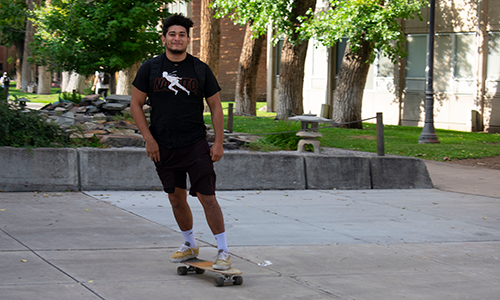 student skateboarding on campus